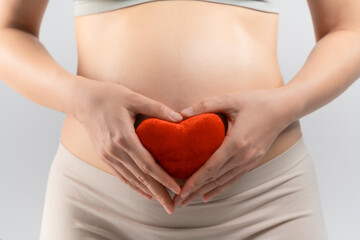 close up of pregnant woman with hearth model  to her infant