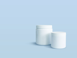 White empty sports nutrition containers on blue background