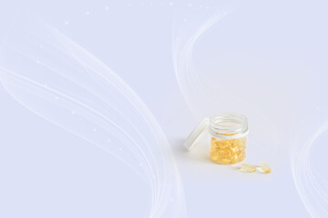 Yellow oil capsules with vitamin D, omega poured from a plastic white bottle. Healthy diet concept