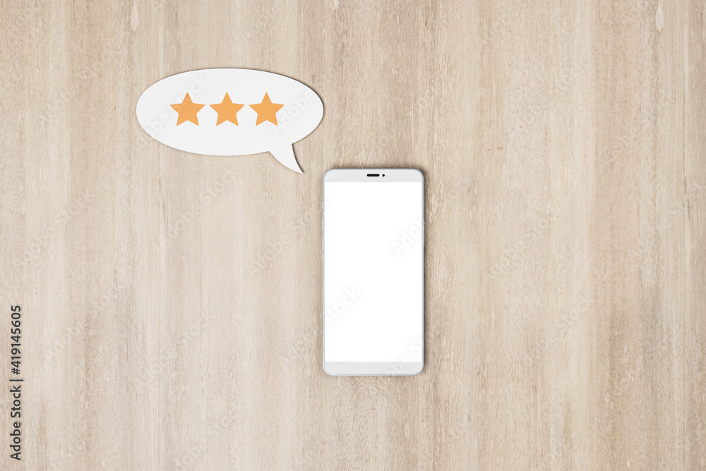 Poster social rating concept with blank white smartphone screen and speech bubble with three stars on woode