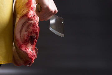 Butcher with ax and meat. Butcher hand with copy space.