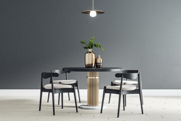 Black round table with wooden chairs around in the center of modern dining room with black wall and...