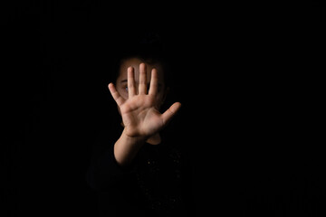 little girl with a raised hand on a black background - Powered by Adobe