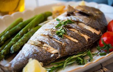 Roasted dorado fish with herbs and vegetables , healthy food