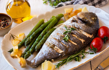Roasted dorado fish with herbs and vegetables , healthy food
