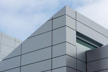 The exterior wall of a contemporary commercial style building with aluminum metal composite panels...