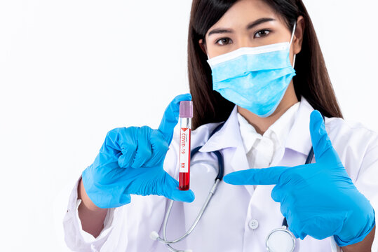 Blurred soft images of Asian attractive doctor woman Holding a vaccine bottle to treat the coronavirus or COVID-19 infection, On white background to health care and virus infection concept.