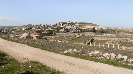 Fototapeta na wymiar The ruins of the outer part of the palace of King Herod - Herodion of the nearby Jewish and Arab settlements in the Judean Desert, in Israel