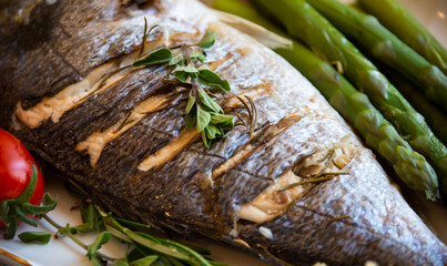 Roasted dorado fish with herbs and vegetables , healthy food