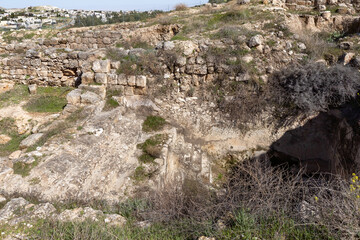 Fototapeta na wymiar Well-preserved remains of the steps to the ritual Jewish bath for bathing - mikveh, in the ruins of the outer part of the palace of King Herod,in the Judean Desert, in Israel