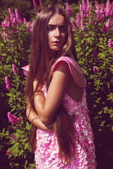 Young woman in pink dress with long hair