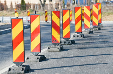 Traffic signs with orange and red colours used to deviate car traffic from a way to another