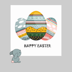 Fototapeta premium Bunny looks at Easter card. Three colorful eggs with phrase Happy Easter