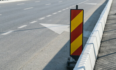 Traffic signs with orange and red colours used to deviate car traffic from a way to another