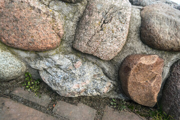 Big granite boulders or sea stones in ancient fortress walls