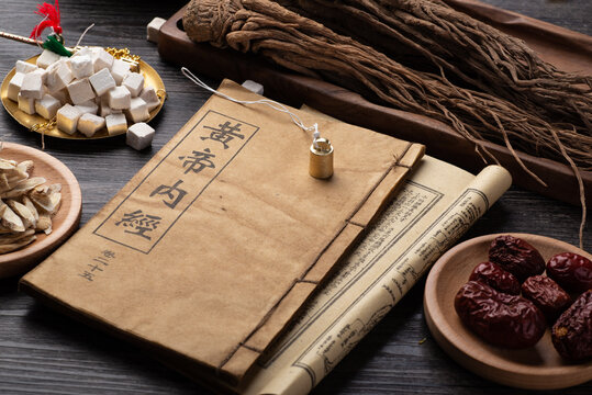 Ancient Chinese Medicine Books And Herbs On The Table