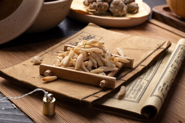 Ophiopogon japonicus，Ancient Chinese medicine books and herbs on the table