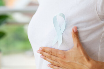 Woman with blue ribbon, prostate cancer awareness