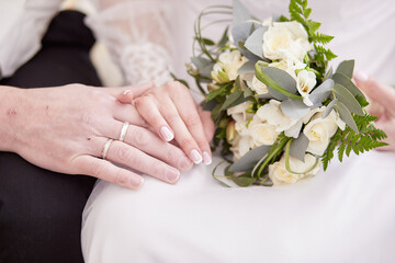 Wedding rings on a pair of bride and groom. Close up, copy space