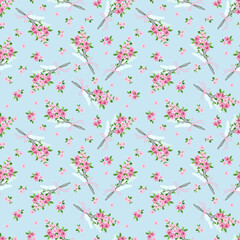 Seamless pattern with a bouquet of small pink flowers and bird feathers.