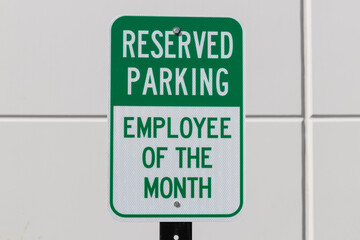 Reserved Parking for the Employee of the Month sign in white and green text.