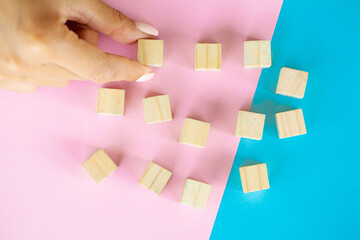 Woman hand putting and stacking blank wooden cubes on desk with copy space for input wording and...