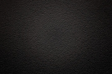 Dark background with fine texture and vignetting with emphasis on the center. An empty flat and clean surface for information. Advertising backdrop
