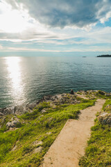 woman sitting at sea beach enjoying the beauty of sunset