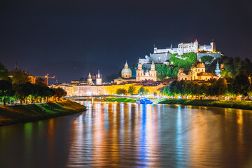 Fototapeta na wymiar Salzburg city shining in the lights at night. Location place Salzburger Land, Austria, Europe.
