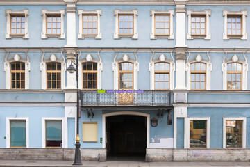 Fototapeta na wymiar Vintage architecture classical facade small blue dirty building front view.
