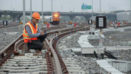 workers at work. engineer sitting on railway inspection. construction worker on railways. Engineer...
