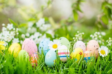 Fresh,beautiful postcard with beautiful easter decoration and painted colorful easter eggs in beautiful nature landscape in spring. Easter eggs on the fresh green meadow.