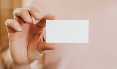 Fototapeta premium Man holding a business card with blank background