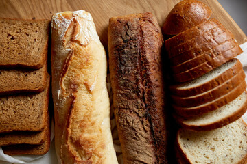 Top view of various kinds of bread on a wooden surface.