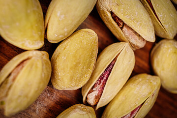 Salted pistachio nuts open shells macro image.