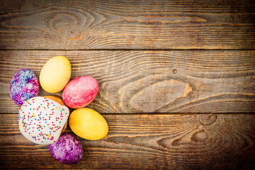 Easter cakes and Easter colored eggs on a wooden background.