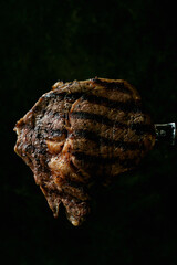 Grilled rib eye steak on the fork