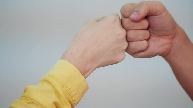 social distance. teamwork. fist to fist commit a respect and brotherhood gesture. business team hands fists. people of different skin colors partnership friendship teamwork solidarity social distance