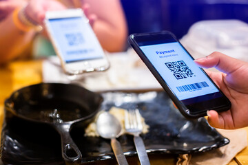 Selective focus to QR code payment and Barcode on smart phone. The concept of cashless technology or digital payment.