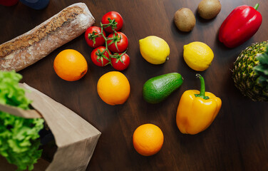 Paper shopping bag full of vegetables and fruits on table in kitchen. Bag food concept. Top view.
