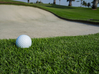 Golf ball on the golf course background large sand hole