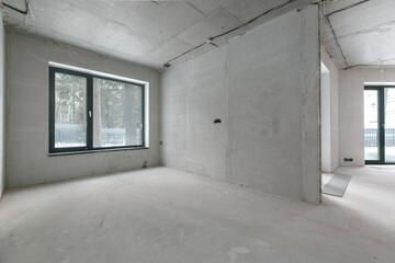 interior of the apartment without decoration in gray colors. rough finish