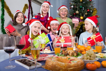 Fototapeta na wymiar Portrait of happy family who is satisfied of presents in time celebration New Year at home.