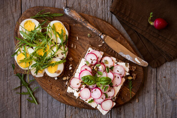Sandwiches on healthy cereal bread with arugula, eggs and radish. Vegetarian snack