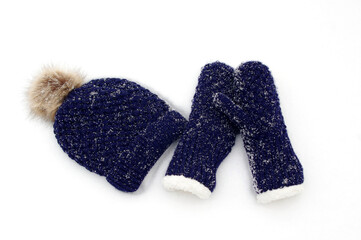 dark blue knit mittens and hat in white snow
