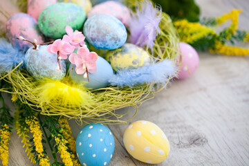 Happy Easter. Congratulatory easter background. Easter eggs and flowers. Background with space for copying. Selective focus.