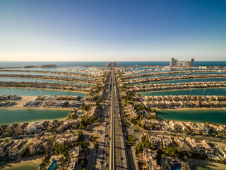 Aerial view of the Palm Jumeirah with Atlantis the Palm luxury hotel in background, an artificial archipelagos in the city centre of Dubai, United Arab Emirates.