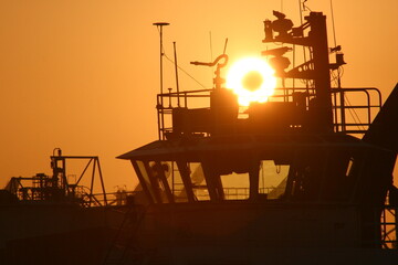 Long Beach California Harbor Sunrise with Tugboat and Sun Shining Through Wheelhouse © Gary Peplow