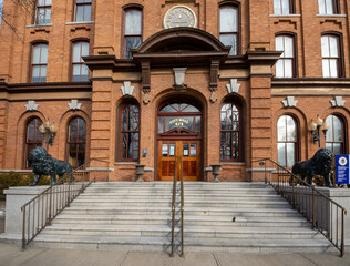 Saratoga Springs, NY - USA - Mar. 6, 2021: A closeup view of the entrance to the Saratoga Springs City Hall, an ornate three-story brick Italianate building built in 1871 by Cummings and Burt of Troy.