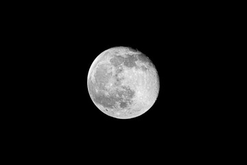 Full lunar moon isolated in the clear night sky